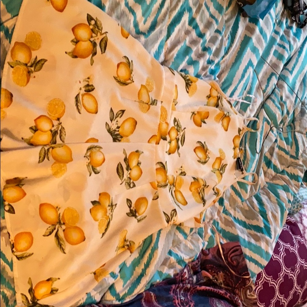 Juniors one piece romper with lemon print.